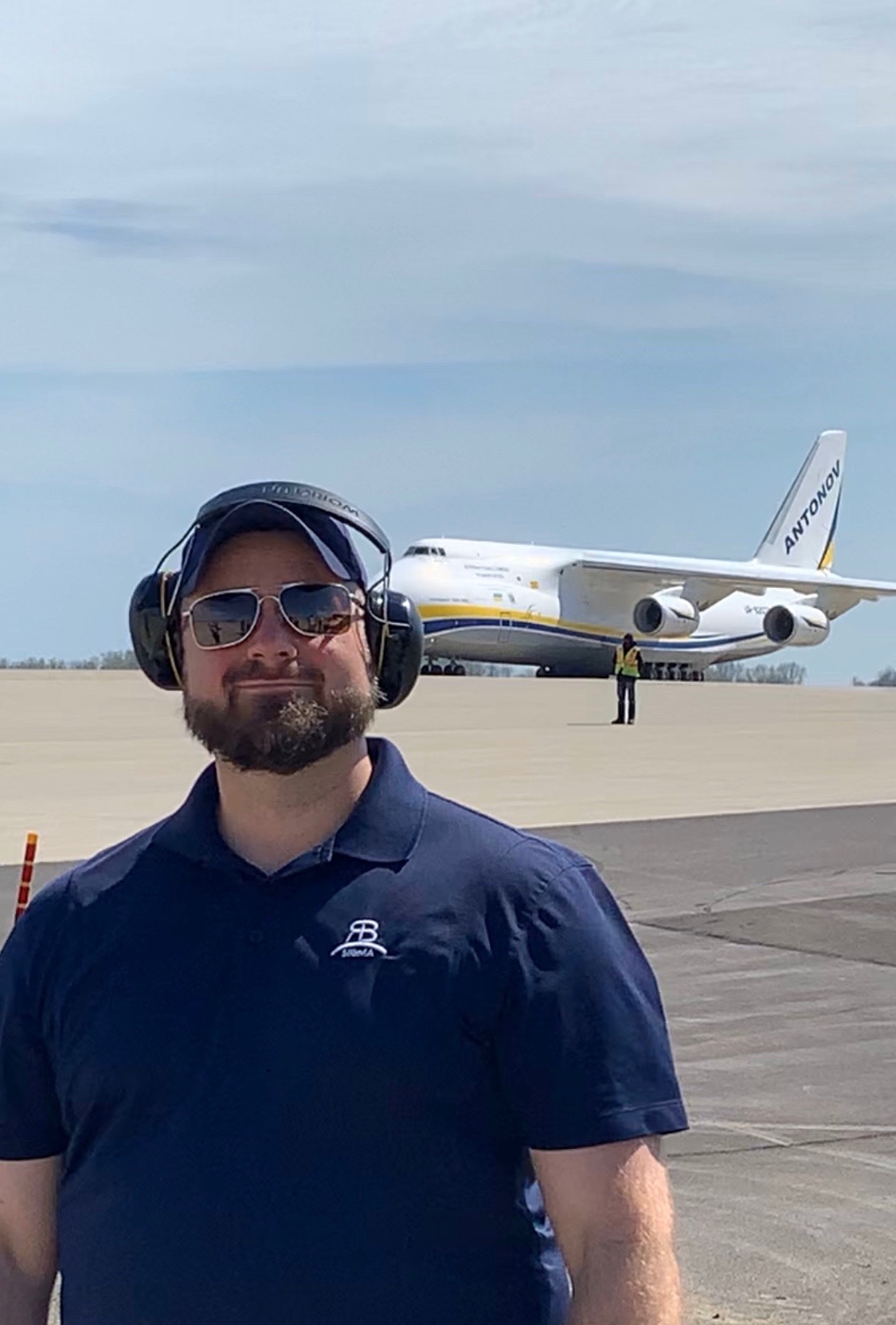 Justin Bloyd standing in front of an Antonov cargo aircraft